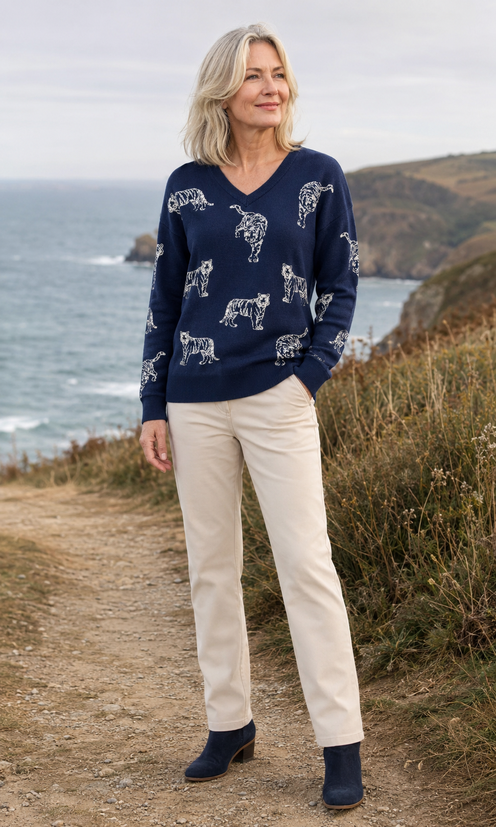 Woman in her 50s wearing the Alice Collins Leopard Jumper on a coastal path