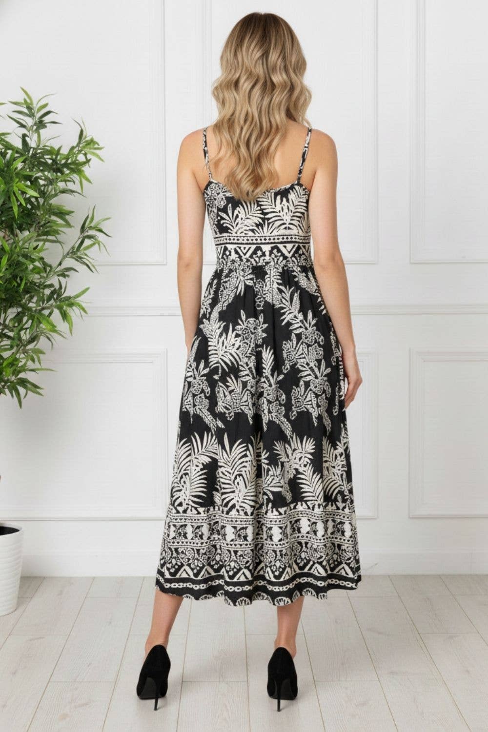 Close-up of shirred bodice and adjustable cami straps on black printed midi dress