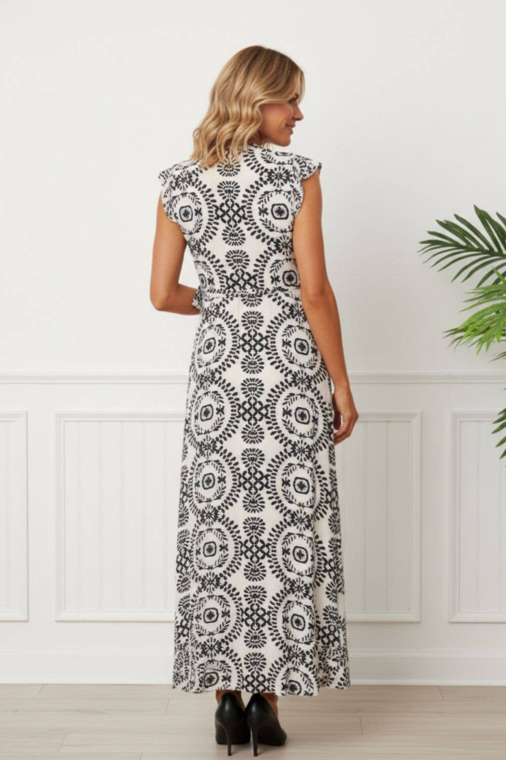 Close-up of shirred bodice and adjustable cami straps on black printed midi dress